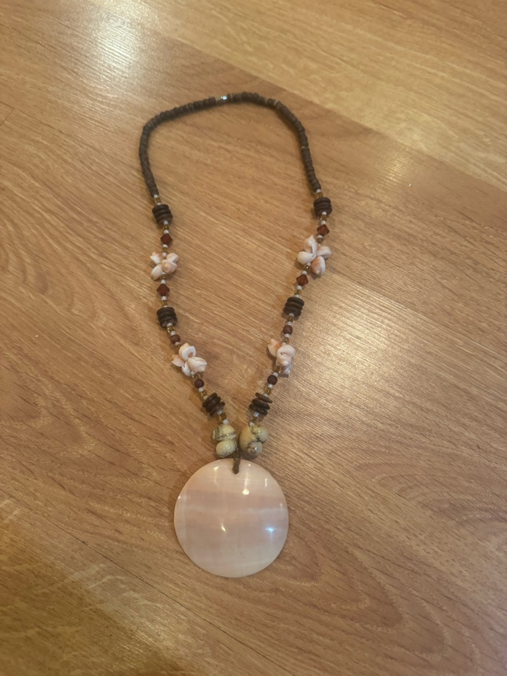 Bohemian necklace with shell and wood beads and mother of pearl pendant